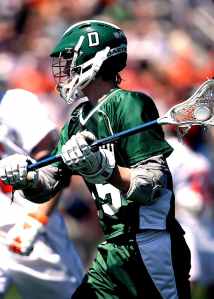 green and white lacrosse player